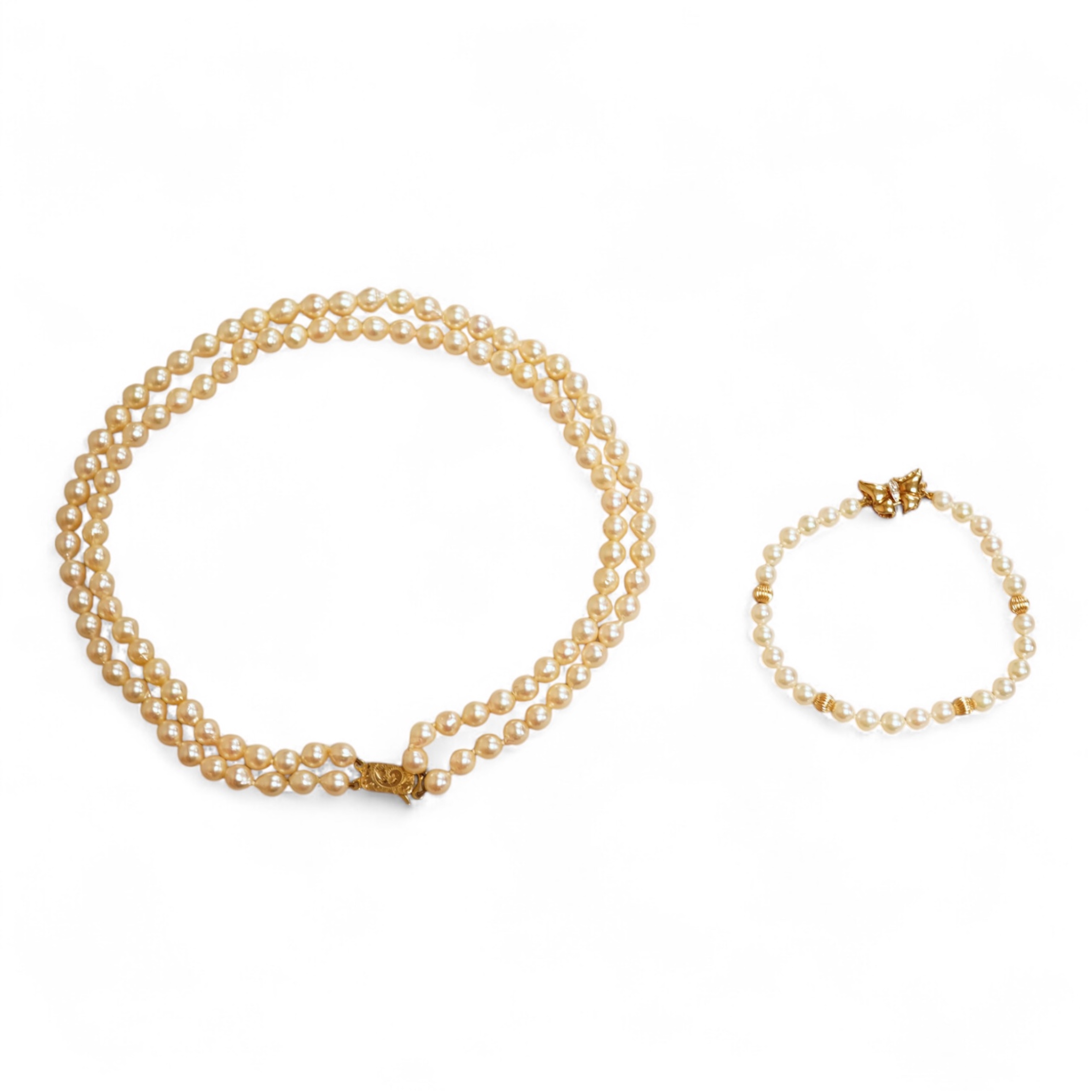 A modern twin strand cultured pearl choker necklace, with an engraved 9ct clasp, approx. 40cm, together with a cultured pearl bracelet, with diamond chip set butterfly shaped 14k clasp, 18cm, with four fluted yellow meta